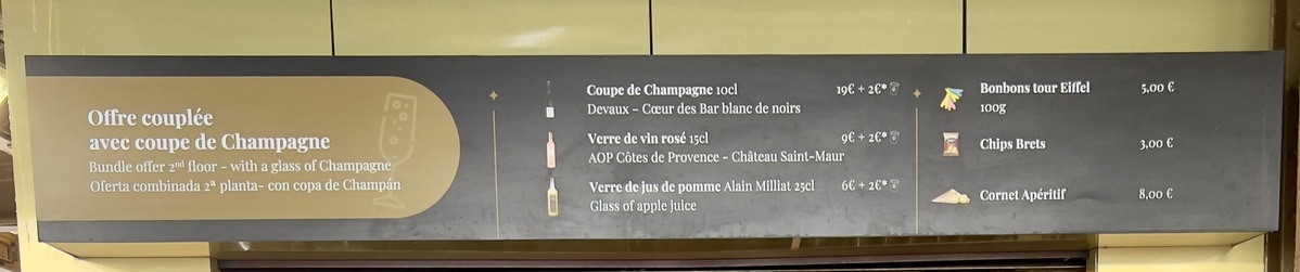 Menu board displaying a bundle offer with a glass of Champagne. Items include Champagne, rosé wine, sweets, chips, and an aperitif. Prices are listed in euros.
