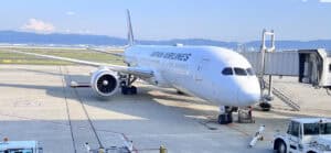 Aircraft parked at the gate ready for boarding on a clear day.