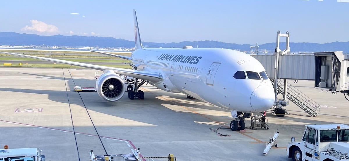 Aircraft parked at the gate ready for boarding on a clear day.