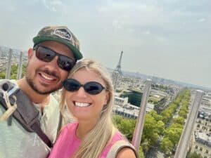 Eiffel Tower and happy travelers enjoying a sunny day in Paris, France.