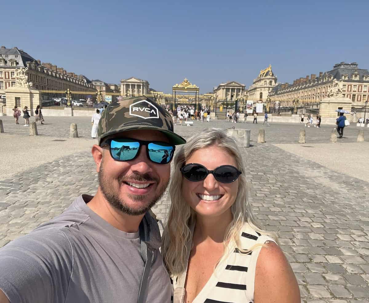Couple smiling in front of Paris landmarks on a romantic getaway. Perfect for couples exploring top.