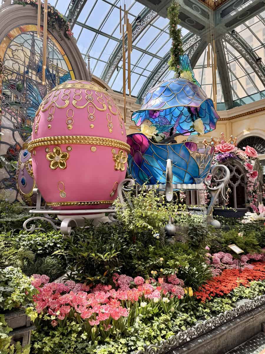 Enchanted glasshouse with vibrant floral arrangements and whimsical decorations.