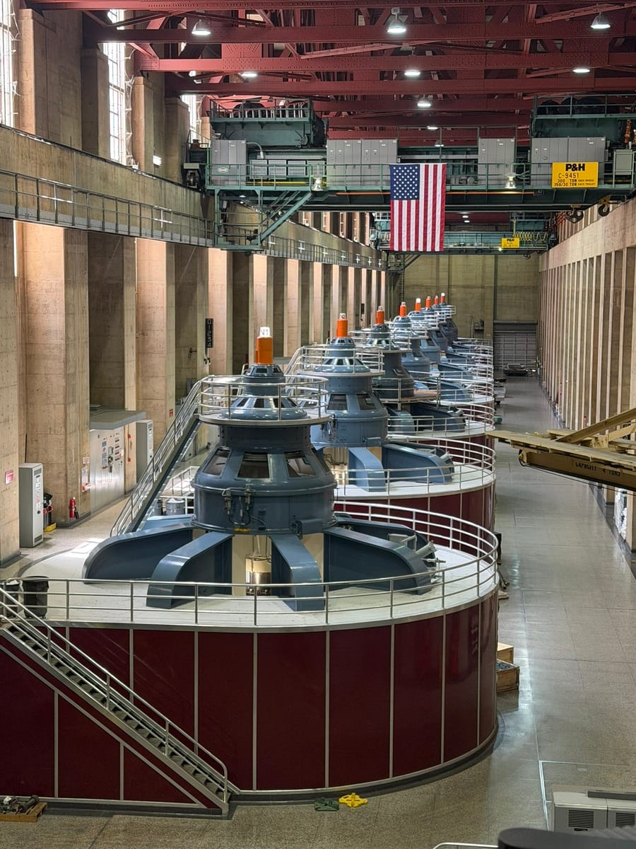 High-capacity cooling turbines inside a large industrial facility for power generation.
