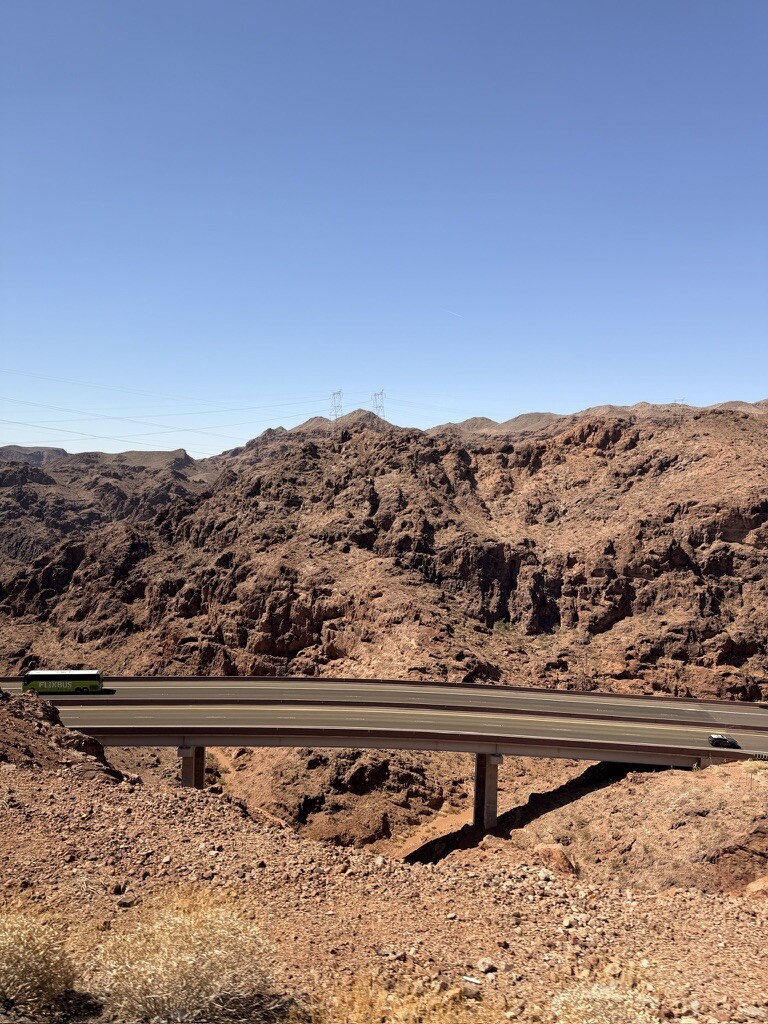 Scenic view of Hoover Dam and surrounding canyon under clear blue sky.