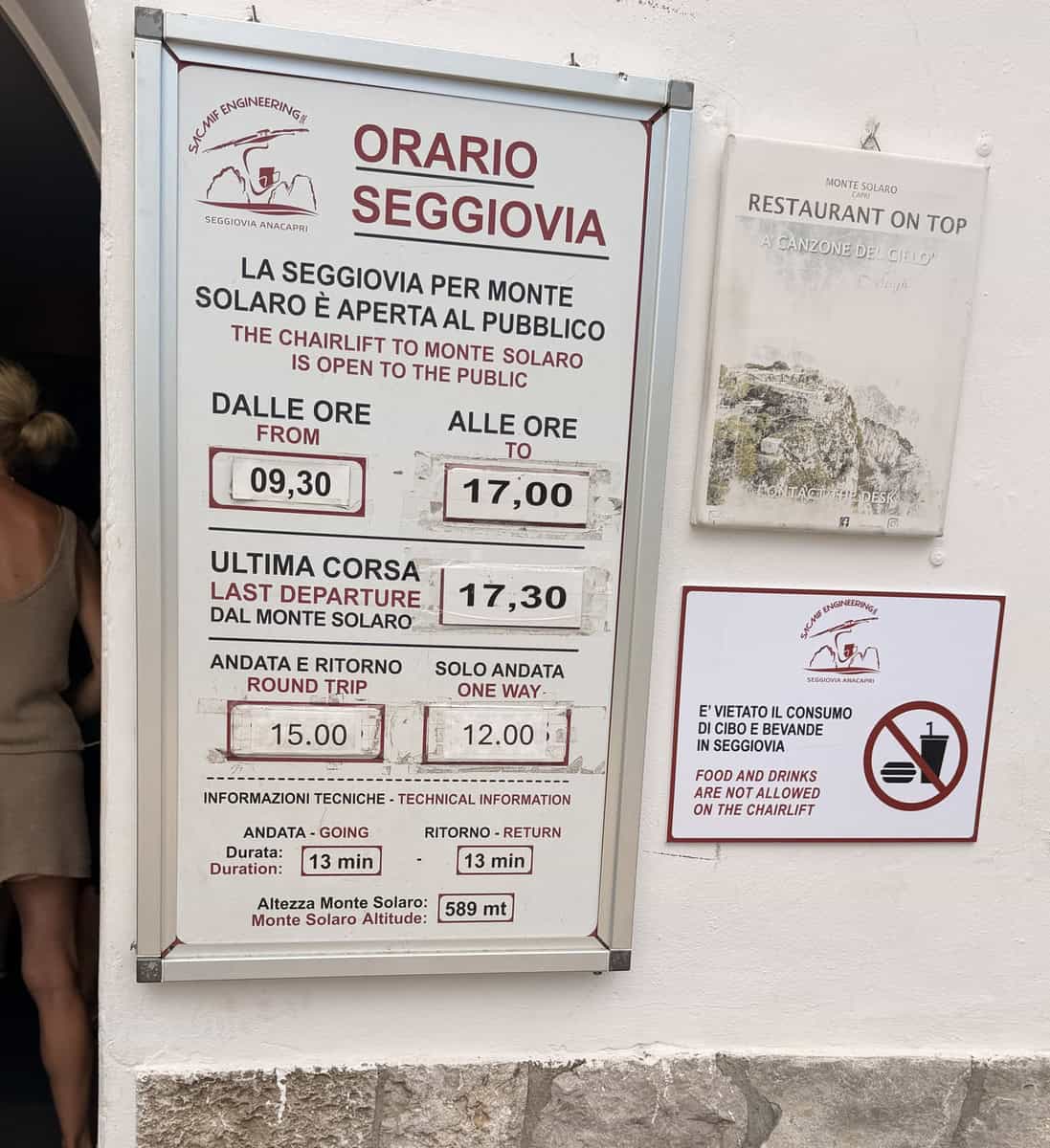 Seating schedule sign at Monte Solaro chairlift in Italy.