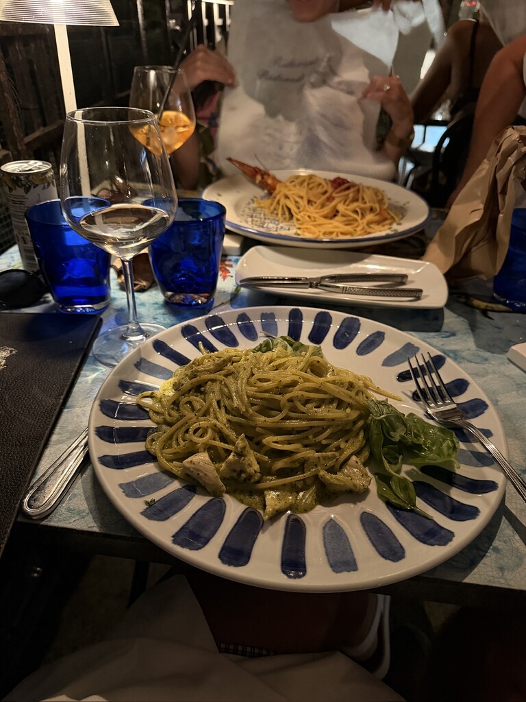 Delicious green pasta dish served at a restaurant in Italy.