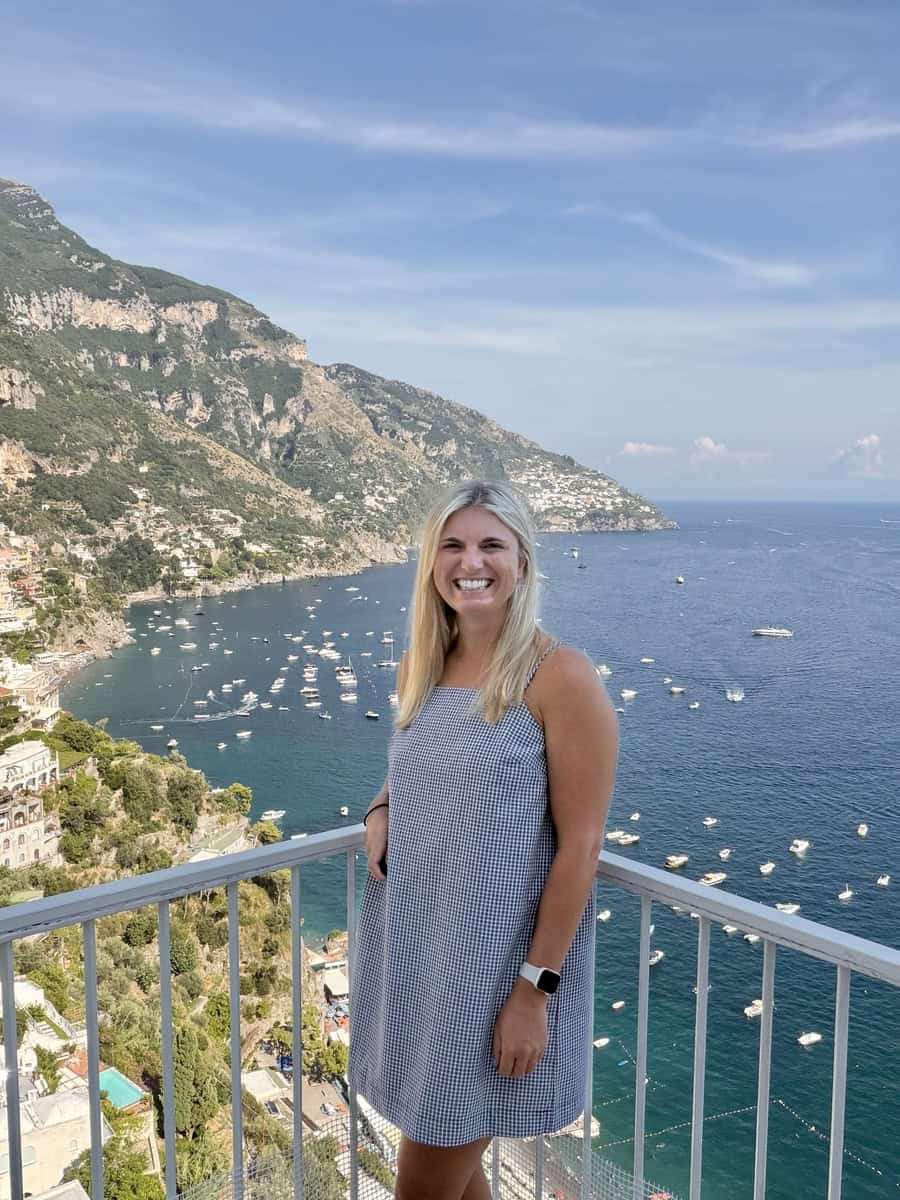 Smiling woman enjoying Amalfi Coast views in Italy.